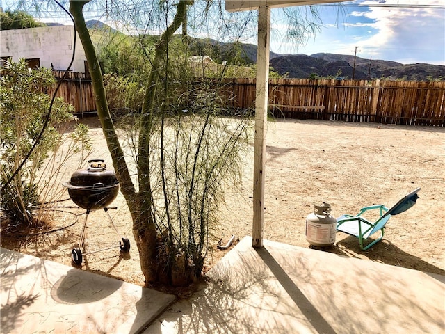 view of yard featuring a mountain view and a patio area