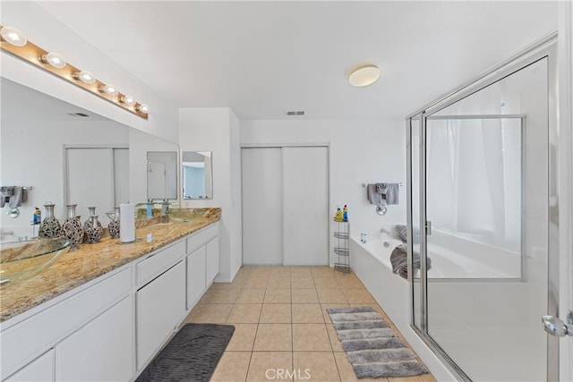 bathroom featuring tile patterned floors, vanity, and shower with separate bathtub