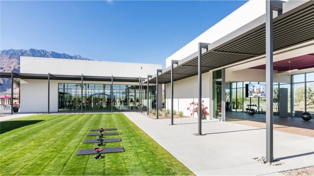 exterior space with a lawn and a mountain view