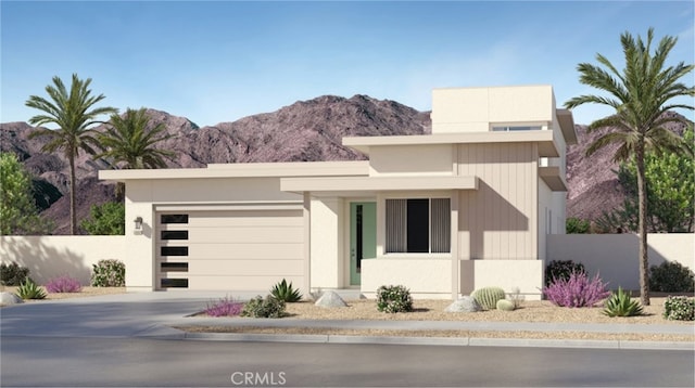 contemporary home with a mountain view and a garage