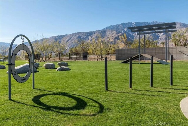 view of community featuring a lawn and a mountain view