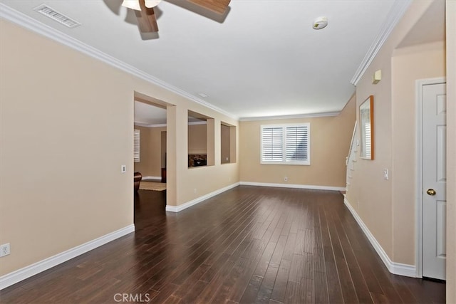 spare room featuring crown molding, dark hardwood / wood-style flooring, and ceiling fan