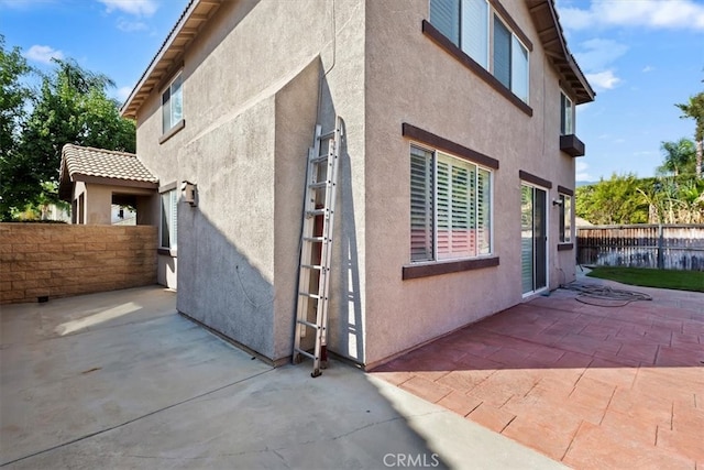 view of side of home featuring a patio area