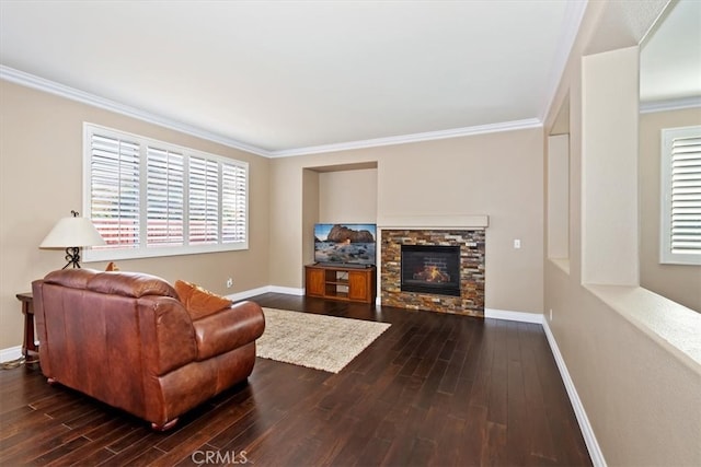 living room featuring crown molding, a fireplace, dark hardwood / wood-style flooring, and plenty of natural light