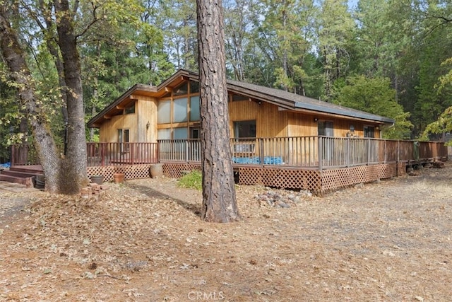 rear view of house featuring a deck