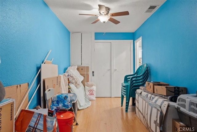 misc room with ceiling fan and light hardwood / wood-style flooring