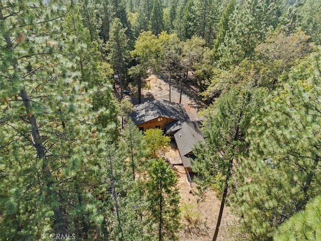 drone / aerial view featuring a view of trees