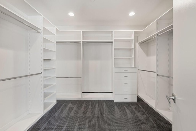 spacious closet featuring dark carpet