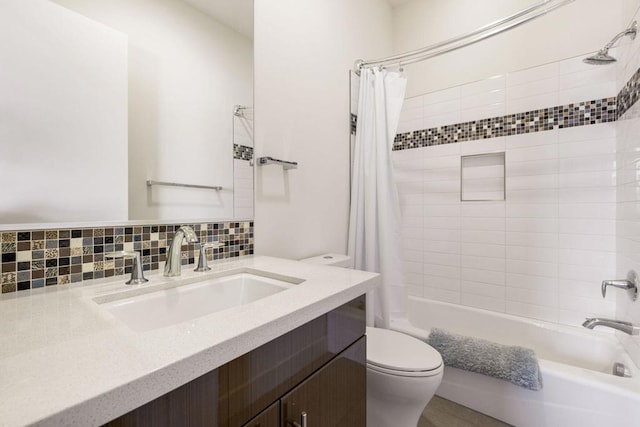 full bathroom with vanity, toilet, backsplash, and shower / tub combo with curtain