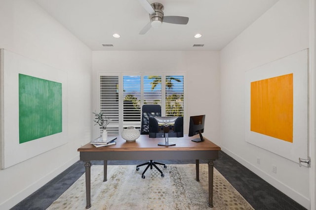 carpeted home office featuring ceiling fan