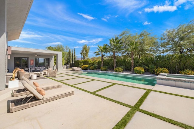 view of pool featuring ceiling fan, an outdoor hangout area, a patio area, and a hot tub