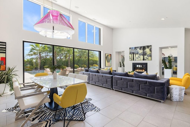 tiled dining space with a towering ceiling