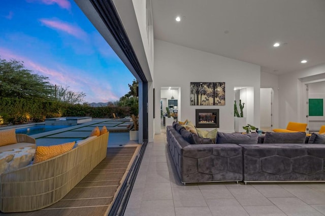 tiled living room with a fireplace and vaulted ceiling