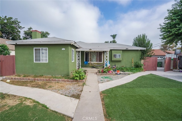 1007 E Kay St, Compton, CA 90221 - view of front of property featuring a gate, fence, stucco siding, a front yard, and a chimney
