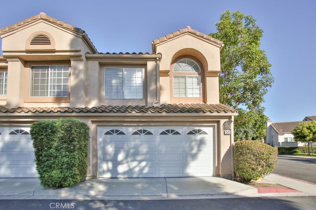 mediterranean / spanish-style house with a garage