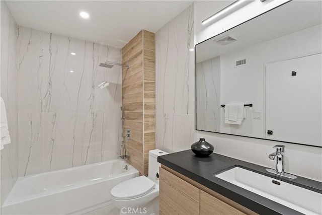 full bathroom with vanity, tiled shower / bath combo, and toilet