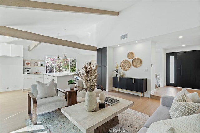 living room featuring beam ceiling, high vaulted ceiling, and light hardwood / wood-style flooring