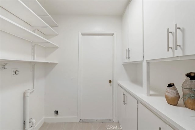 laundry room with washer hookup, hookup for a gas dryer, and cabinets