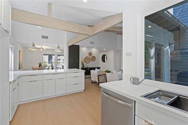 kitchen featuring sink, hanging light fixtures, stainless steel dishwasher, light hardwood / wood-style floors, and white cabinetry