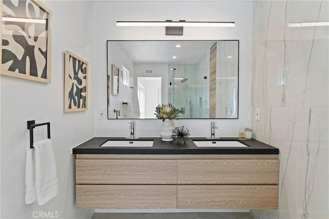 bathroom featuring vanity and an enclosed shower