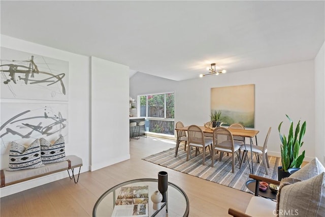 dining room featuring light wood-type flooring and an inviting chandelier