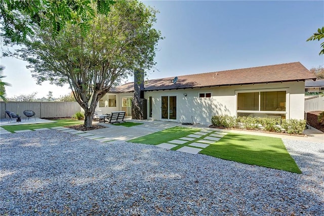 back of property with a patio