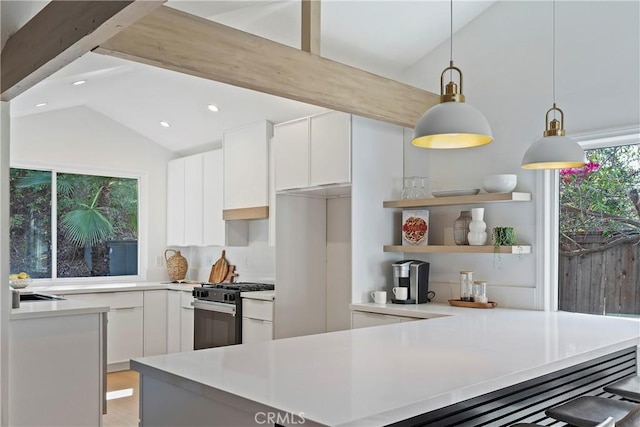 kitchen with gas stove, white cabinetry, hanging light fixtures, lofted ceiling with beams, and backsplash