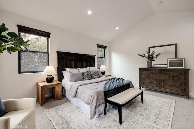 carpeted bedroom featuring multiple windows and lofted ceiling