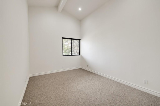 carpeted spare room featuring lofted ceiling with beams