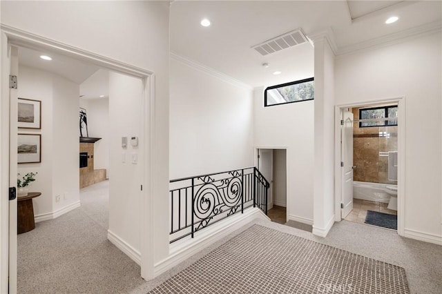 corridor with light colored carpet and ornamental molding