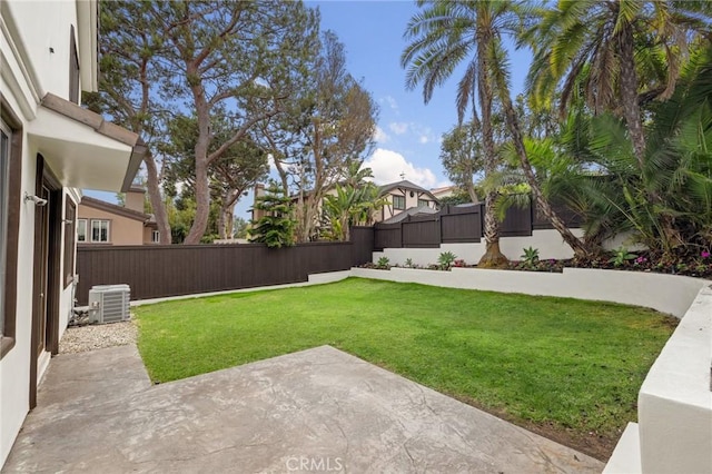 view of yard featuring central AC and a patio