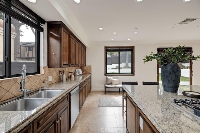 kitchen featuring decorative backsplash, plenty of natural light, appliances with stainless steel finishes, and sink