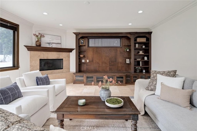 living room with a tile fireplace, crown molding, and light tile patterned floors