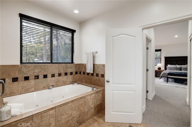 bathroom with a relaxing tiled tub