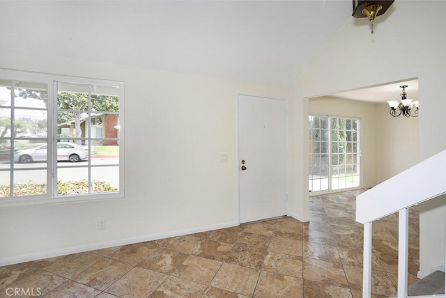 foyer featuring vaulted ceiling and an inviting chandelier