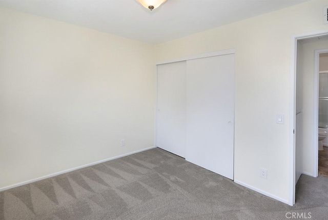 unfurnished bedroom with carpet flooring and a closet