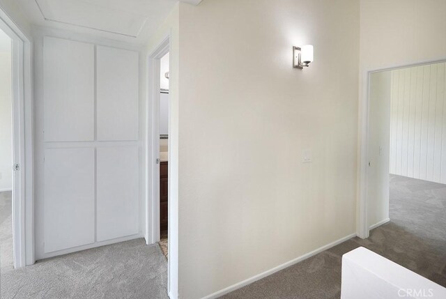 hallway with light colored carpet