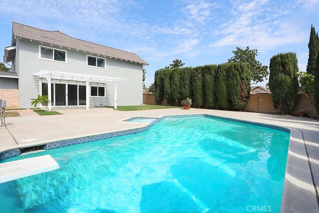 view of swimming pool with a pergola, a patio, and a diving board