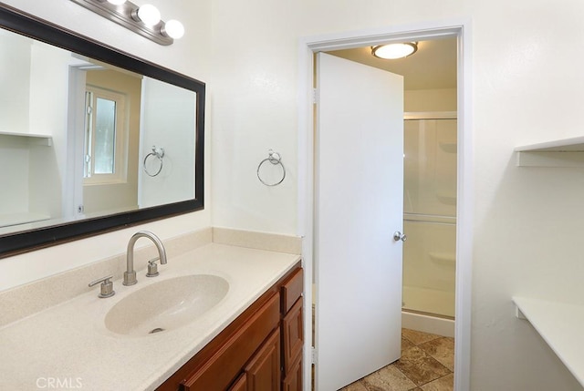 bathroom with vanity and a shower with shower door