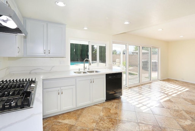 kitchen with dishwasher, sink, light stone countertops, range hood, and white cabinetry