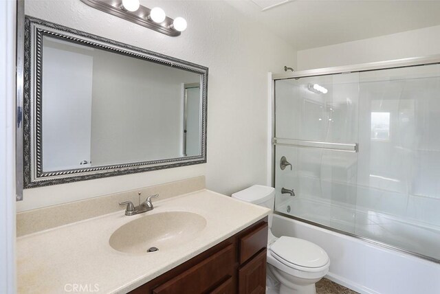 full bathroom featuring vanity, toilet, and enclosed tub / shower combo