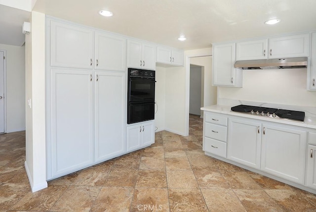 kitchen with double oven, white cabinetry, and gas cooktop