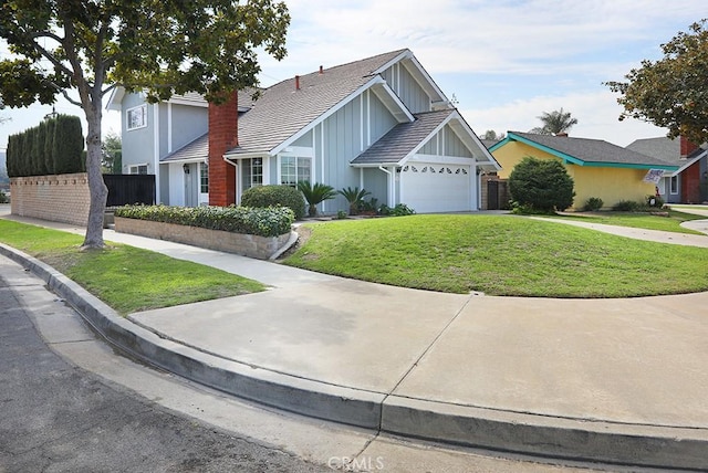 view of front property featuring a front lawn and a garage