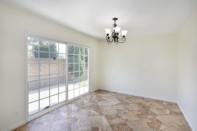 unfurnished dining area featuring an inviting chandelier