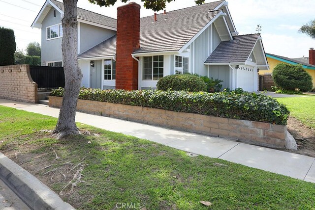 view of front of home featuring a garage and a front lawn