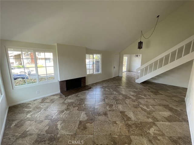 unfurnished living room with a brick fireplace and vaulted ceiling