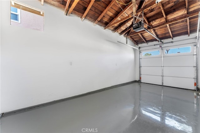 garage with a garage door opener and wood ceiling