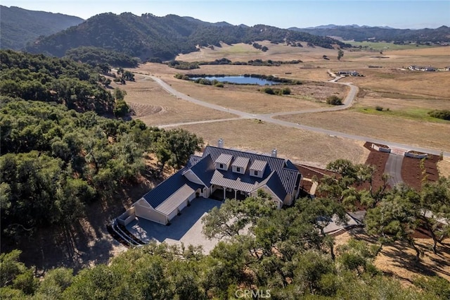 aerial view with a water and mountain view and a rural view