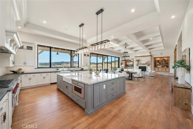 kitchen with white cabinets, gray cabinets, coffered ceiling, and a sink