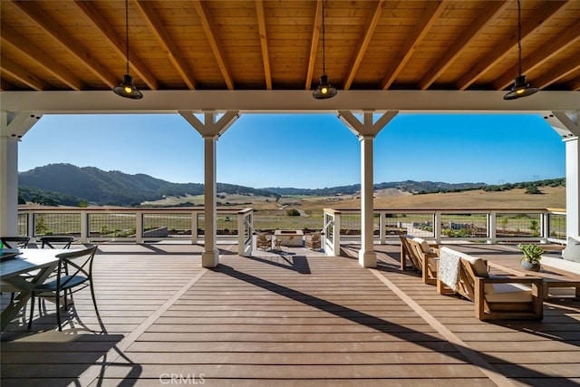 wooden deck featuring a rural view and a mountain view